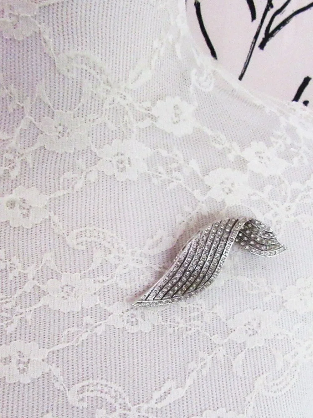 Clear pave rhinestone free form ribbon brooch in silver tone setting
